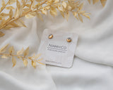 Gold and Porcelain Black Speckled Mini Circle Studs.